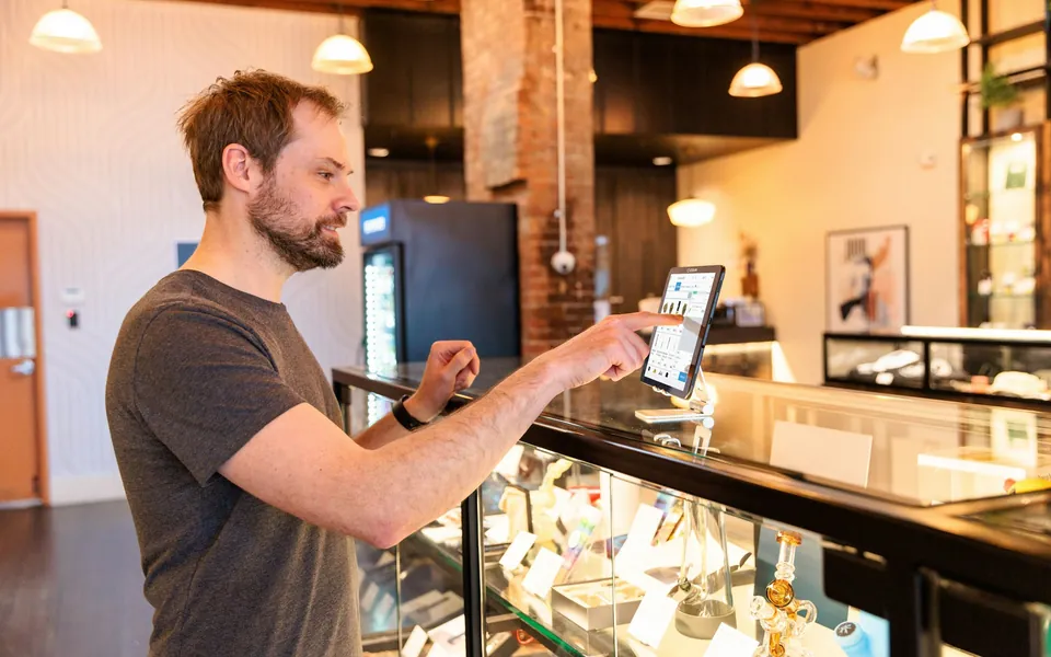Business owner using a tablet at the store counter