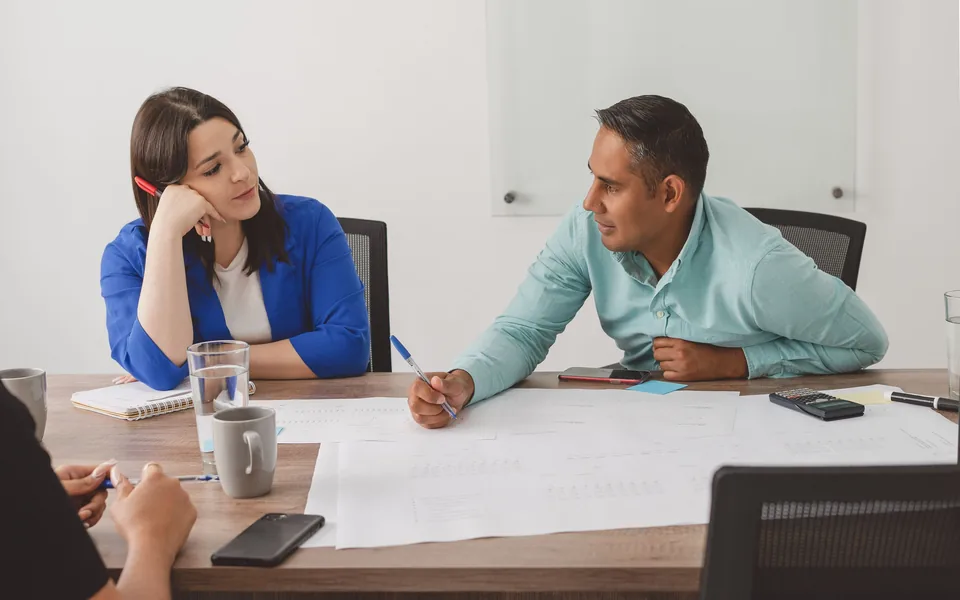 IT advisor reviewing pending tasks with an employee at the office